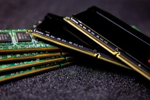 RAM modules stacked on a dark surface showing green circuit boards and copper Stock Photos