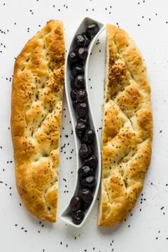 Ramadan Bread,Pide cut in half and black olives between them Stock Photos