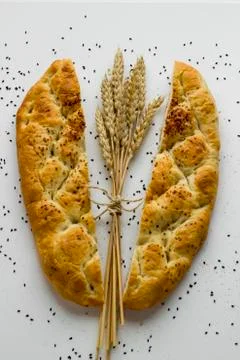 Ramadan Bread,Pide cut in half and a bunch of wheat ears between them Stock Photos