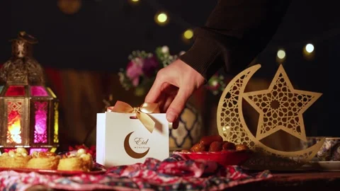 A Ramadan celebration table with a gift box and traditional food Stock Footage 310594879