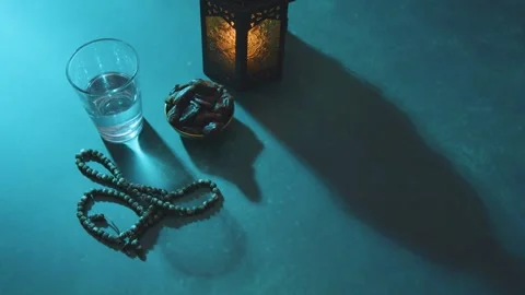 Ramadan Iftar Items with Dates Water Prayer Beads and Lantern 4K Stock Footage 332158185