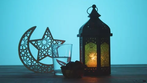 Ramadan Iftar Setting with Lantern Dates Water and Crescent Moon 4K Stock Footage 332158203