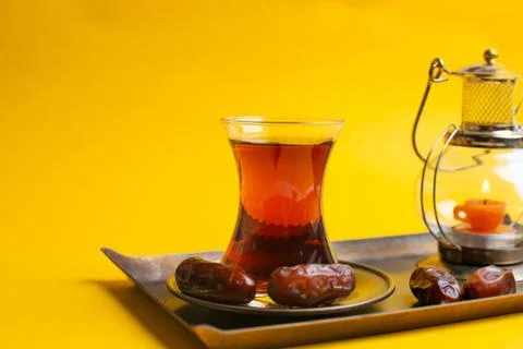 Ramadan Kareem Festive, close up of dates on plate with oriental candle lamp  Stock Photos