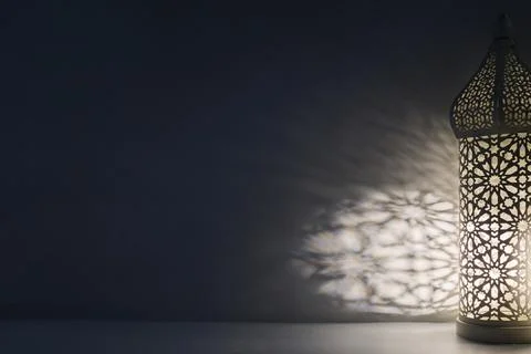 Ramadan lantern casting intricate islamic pattern shadows Stock Photos
