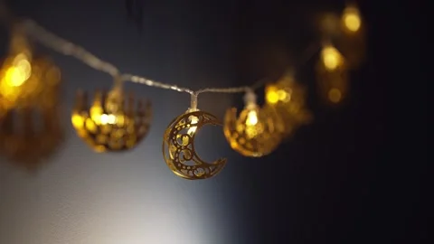 Ramadan lights. Gold crescent moons hang gracefully, reflecting the joy of Stock Footage 323979730