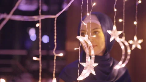 Ramadan or Eid Mubarak. Muslim Woman Touching Glowing Moon and Star Decor Vidéo 264741904