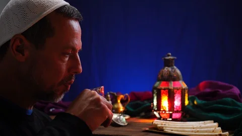 Ramadan under lockdown. A Muslim man ends his fast with water and dates Stock Footage 129451068