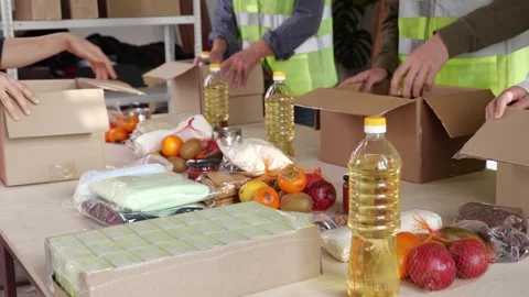 Ramadan Volunteer Program. A volunteer team packing donation food. Humanitarian Stock Footage 300424041