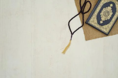 Ramadhan objects. Holy Quran, beautiful beads, prayer rugs, and moslem clothes. Stock Photos