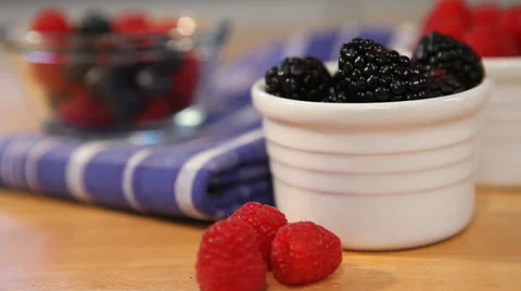 Ramekin of mixed berries put down by hand, dolly right Stock Footage 33581110