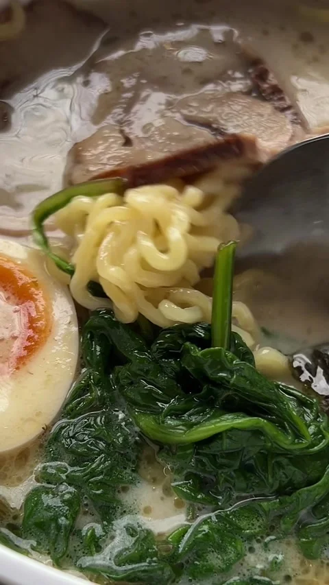 Ramen egg broth Chopsticks Eating Japanese tonkotsu ramen thick creamy pork bone Stock Footage 302805253