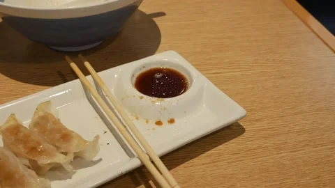 Ramen shop table with bill for Pay at the counter. Stock Footage 312801409
