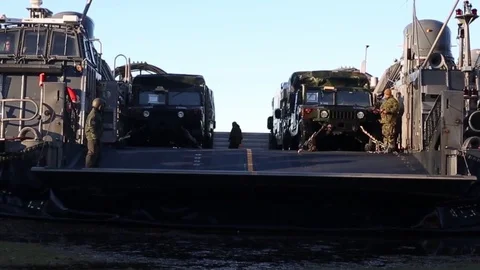 Ramp lowering on LCAC for vehicles to exit during amphibious assault Stock Footage 97498011
