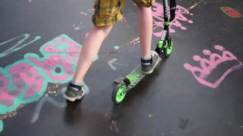 The ramp for skaters and rollerbladers - boy riding a scooter active lifestyle Stock Footage 64582581