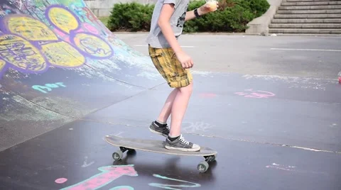 Ramp for skaters and rollerbladers - boy riding a skate with cocktail in hand Stock Footage 64582666