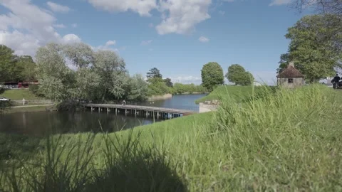 Rampart grass framing the moat and footbridge at Kastellet Stock Footage 341288960