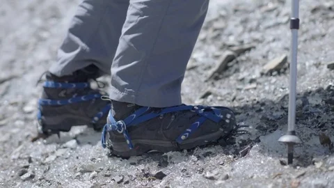 Rampon on winter boot and tracking sticks for climbing irons. Hiking mountain Stock Footage 82211319