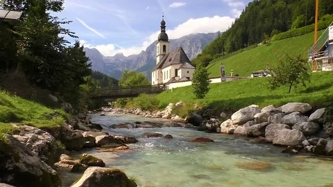 Ramsau Germany - View of Pfarrkirche St. Sebastian and the mountain stream Stock Footage