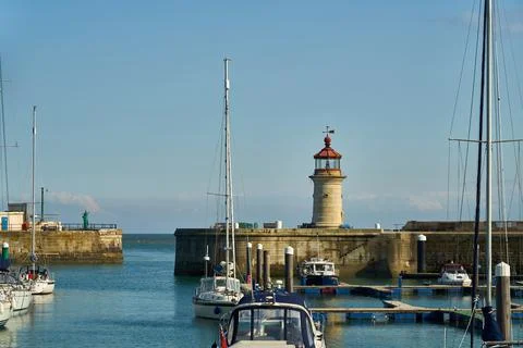 Ramsgate Lighthouse stands next to the main harbour entrance. Stock Photos