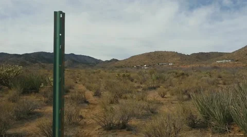 A ranch hand pounding in a post for a fence Видео 60277491