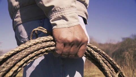 Rancher Gripping Rope While Preparing to Rope Cattle on an Argentine Ranch - 4K Stock Footage 284752006