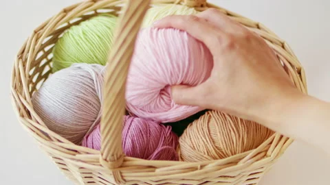 Рand takes ball of woolen threads from basket yarn Stock Footage 211732597