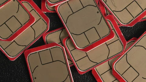 Random Arrangement of SIM Cards with Red Borders on Black Texture Stock Footage 337215206
