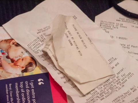 Random bills and receipts on table top student life Stock Photos