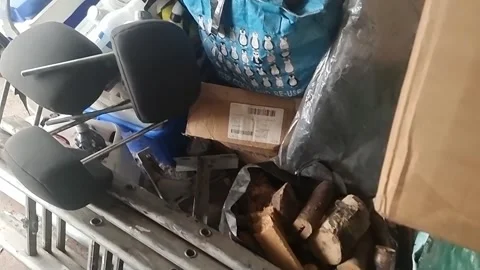 Random collection of untidy household clutter and stacked workshop tools Video stock 336940082