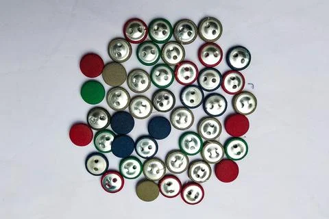 Random colored wrapped buttons on the fabric texture. Фото