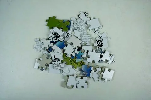 Random jigsaw puzzle incomplete concept background. A pile of uncombed pieces Stock Photos