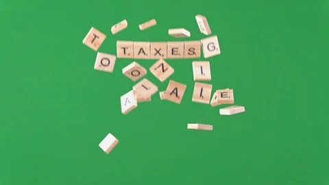 Random letters being thrown into the air in slow motion spelling the word taxes 動画素材 100694142