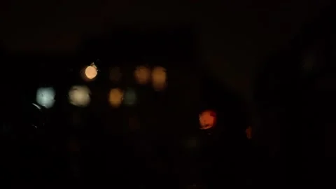 Random lightning with rain on the window with blury background lights Stock Footage 161785099