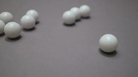 Random movement of white balls on gray suface Stock Footage 147109410