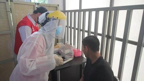 RANDOM PEOPLE GET ANTIGEN SWAP TEST AT TANAH ABANG STATION, JAKARTA Stock Footage 156019305