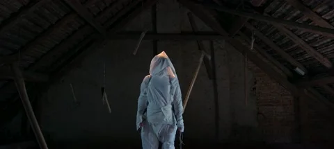 Random Person In Attic Sourrounded By Knives Hanging From Above 動画素材 138084834