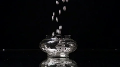 Random Pills being dropped into an antique jar in slow motion 120fps Stock Footage 197085494