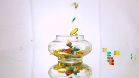 Random Pills being dropped into an antique jar in slow motion 120fps Stock Footage 197085846