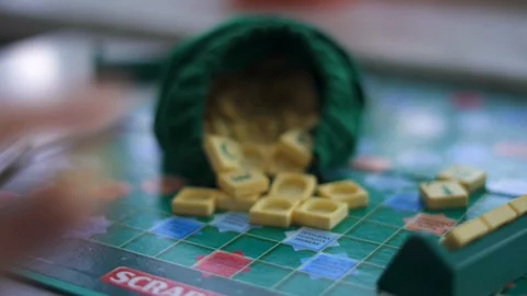Random Scrabble game letter tiles with score value coming out Stock Footage 126350041
