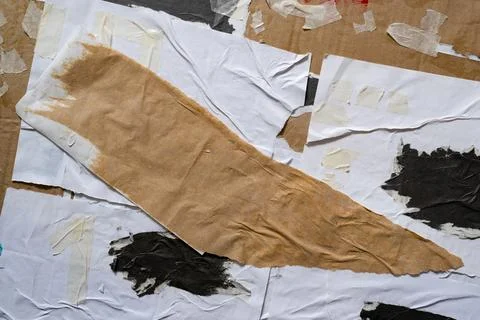 Random shape torn paper glued onto a cardboard texture Stockfoto's
