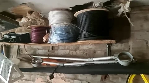 Random stacked wiring and household clutter on home garage shelf junk storage Stock-Footage 336814105