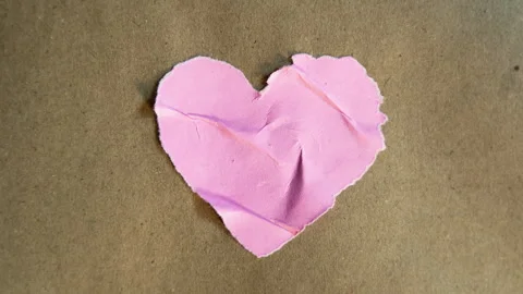 Random texture of pink heart shape paper on brown paper Stock Footage 326022475