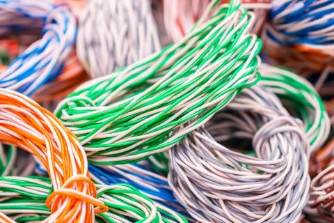 Random weaving of colored wire is close up. Multicolored wires entangled in m 库存照片