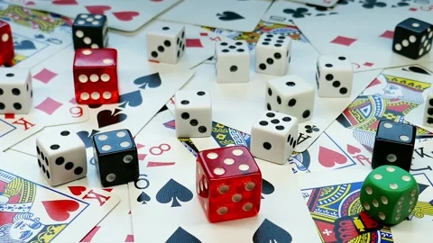 Randomly placed playing cards and colored dice Stock Footage 219779170