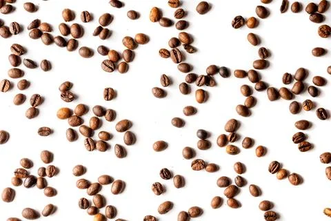 Randomly Scattered Coffee Beans on White Background Flat Lay Stock Photos
