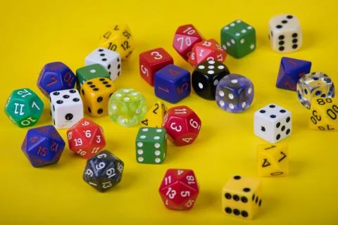 Randomly scattered game dice different sizes and colors Stock Photos