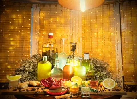 The range of alcoholic tinctures in the bar on the table near the window with Foto stock