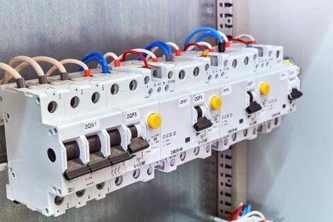 A range of different modular electrical devices in an electrical Cabinet. Stock Photos