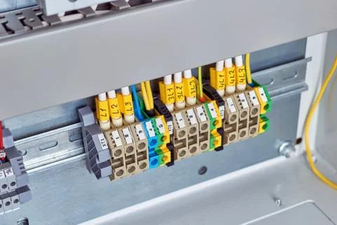 A range of electrical terminals fixed in an electrical Cabinet. Stock Photos