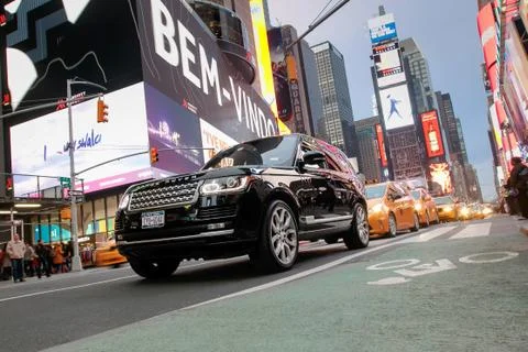 Range Rover and cabs on Times Square Stock Photos